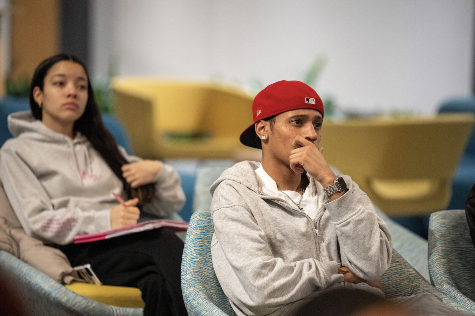 Two young people listening closely during a teaching