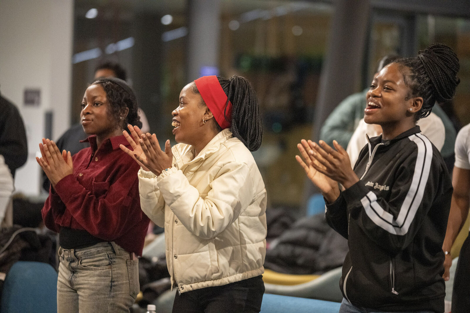 Young women clapping and rejoicing in worship at a Generation Of Yahweh gathering